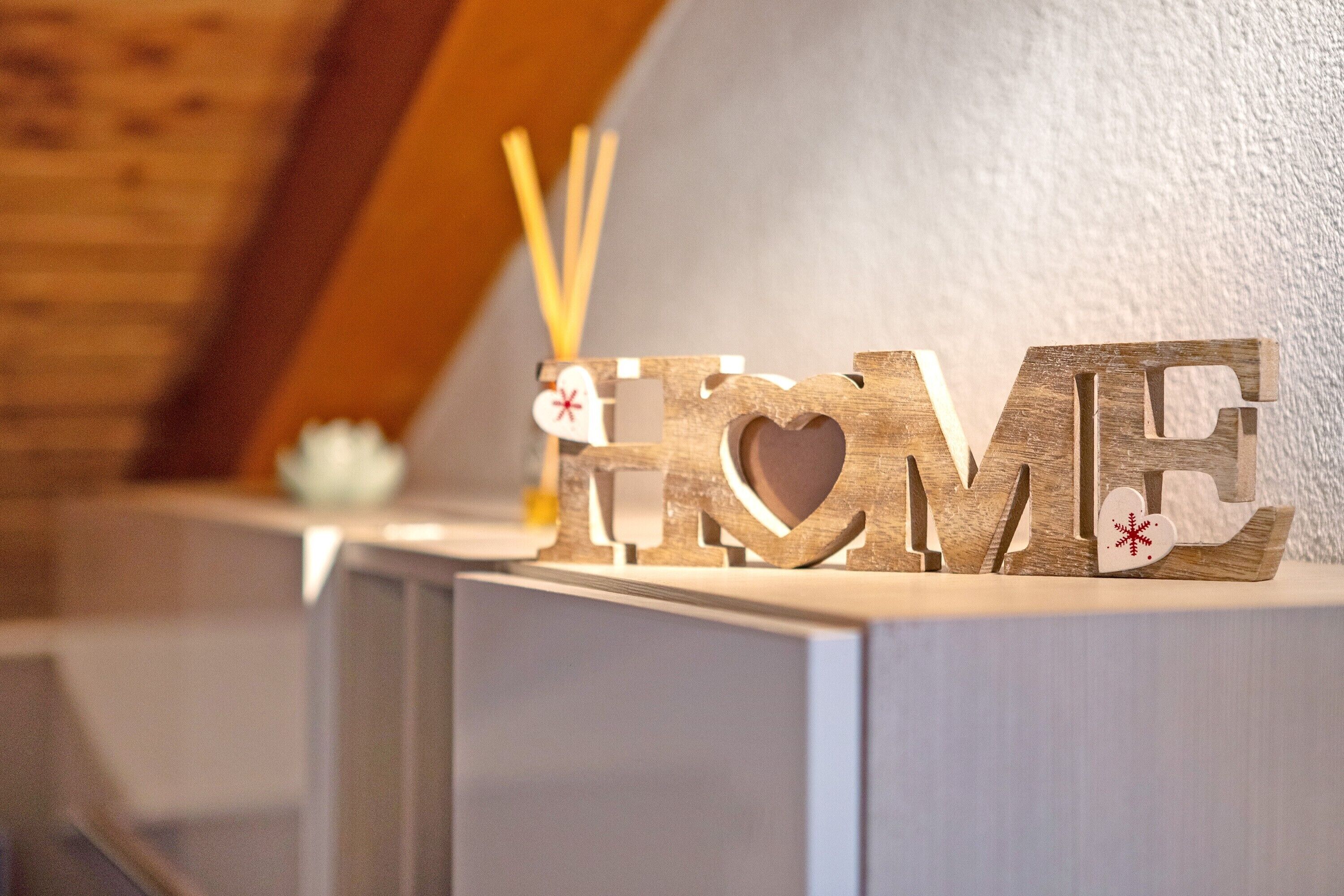 A wooden sign with the word 'HOME' and decorative elements.