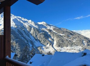 Enjoy breathtaking views of snow-covered peaks and forested slopes from the cabin's balcony.