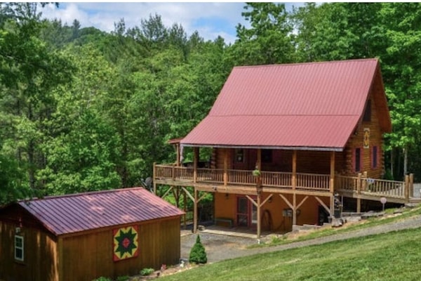 Beside the Still Waters- side of log cabin.