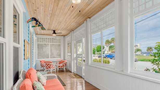 A sunroom with a wooden ceiling, white walls, and large windows. - THE BLUE HOUSE AT OLD COLORADO INN (Stuart)