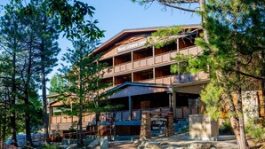 A two-story lodge with a wooden facade, a covered entrance, and a stone sign. - Mount Lemmon Lodge (Mount Lemmon)