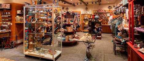 A boutique store with various items on display, including jewelry, clothing, and home decor.