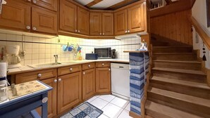 A kitchen with wooden cabinets, a dishwasher, and a microwave.