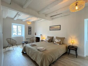 Cozy retreat with a large bed, bedside tables, and a window overlooking the surroundings.