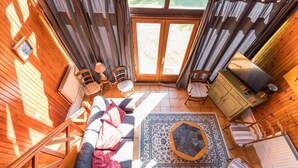 A cozy room with a sofa, chairs, a rug, and a wooden cabinet. - Gite de Pernaout - BELIS (BELIS)