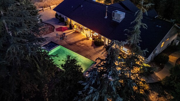 A residential property with a swimming pool, patio furniture, and a covered outdoor seating area. - Scenic Mountain Views w/ Game Room, Pool & Hottubs (Oakhurst)