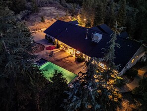 A residential property with a swimming pool, patio furniture, and a covered outdoor seating area. - Scenic Mountain Views w/ Game Room, Pool & Hottubs (Oakhurst)