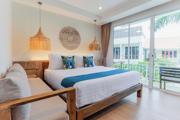 A modern bedroom with a wooden bed, two hanging lamps, a large window with a view of the outside, and a decorative wall piece. - LOVE Beach Club (Koh Samui)