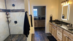 A modern bathroom with a shower, a sink, and a mirror. - Rusty’s Getaway is a rustic/modern handicap accessible, family friendly space.  (Findlay)