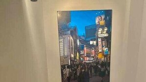 A painting of a busy street scene with people and buildings.