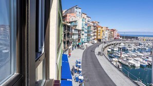 A coastal street with colorful buildings, a marina, and a clear sky. - Old Port, Apartamento con Vistas al Puerto (Bermeo)