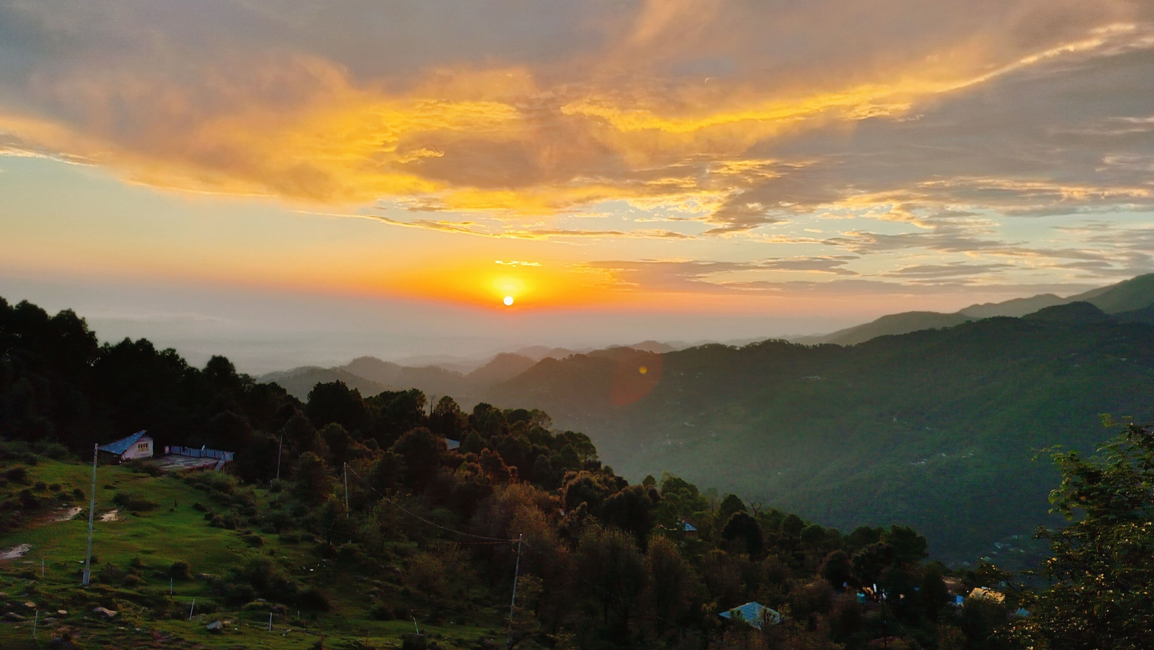 A mountainous landscape with a sunset.