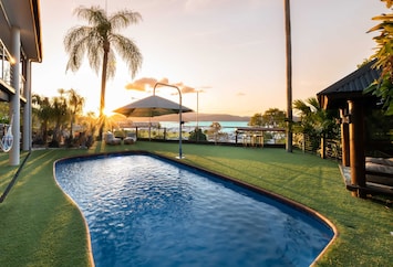 Watch the sunset from the private pool over Coral Sea Marina