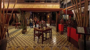 A spacious lobby with a high ceiling, tiled floor, and multiple dining areas. - RESIDENCE 1960 (Siem Reap)