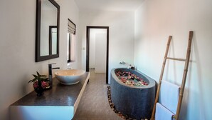 A modern bathroom with a large mirror, a white sink, a freestanding bathtub, and a bamboo ladder. - RESIDENCE 1960 (Siem Reap)