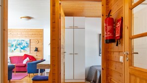 A wooden interior with a dining area, a wardrobe, and a bed. - Urupää b 6 by Interhome (Inari)