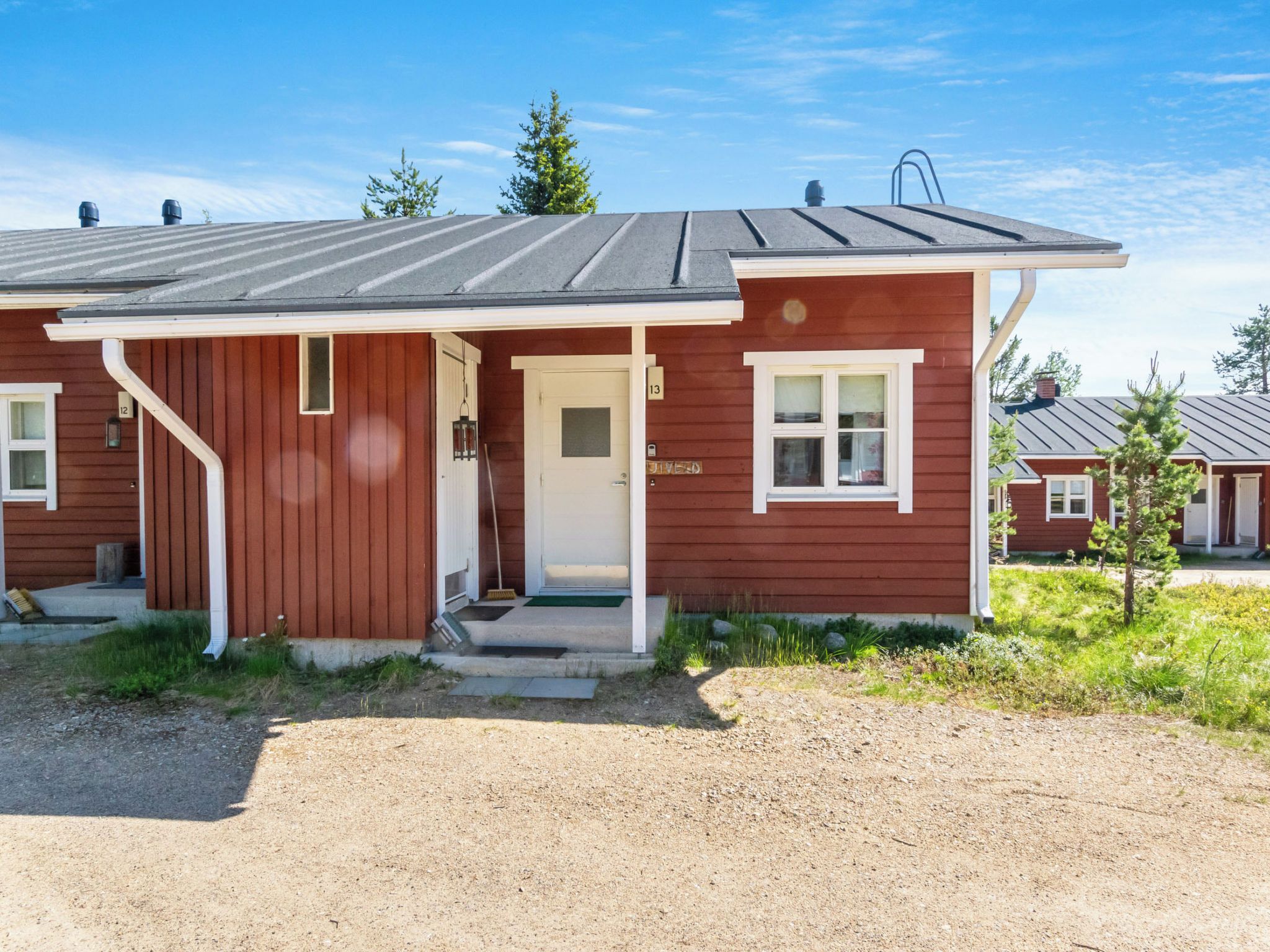 A single-story house with a front porch, a door, and a small window.