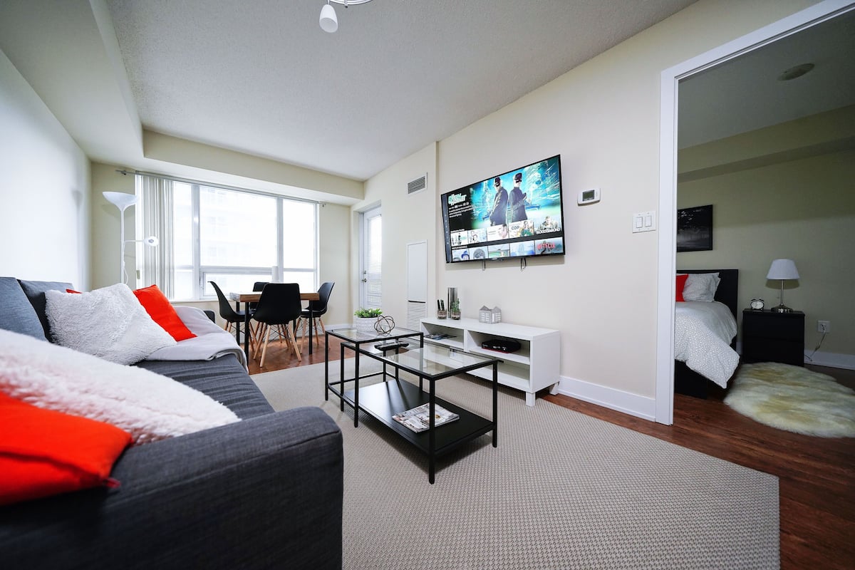 Signature Apartment | Living area | 65-inch TV with cable channels
