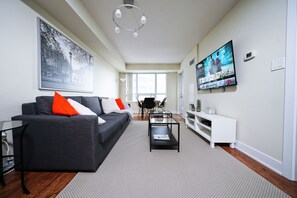 Signature Apartment | Living area | 65-inch TV with cable channels - RivetStays - The Infinity (Toronto)