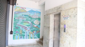 A reception area with a mural depicting various landmarks and a sign indicating the 2nd floor reception. - Smile stay Karanji Comforts (Bengaluru)