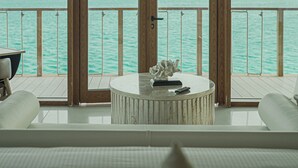 A round table with a sculpture and a remote control, set on a balcony with a view of the sea. - Tawila Island Resort (Hurghada)