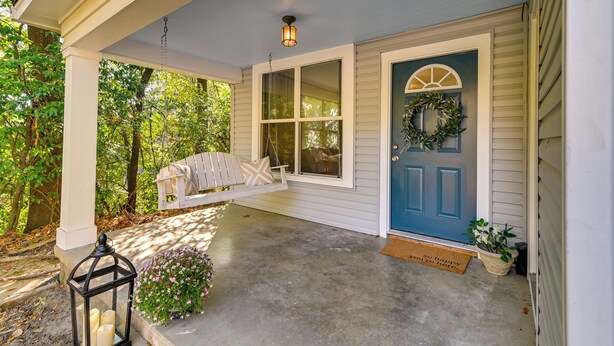 A porch with a blue door, a white bench, and a lantern. - Centrally Located Home ~ Steps to Oxford Square! (Oxford)