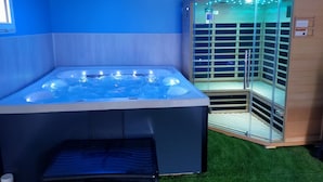 A hot tub with a glass enclosure and a sauna.