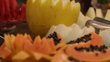 A fruit platter with various sliced fruits and a decorative arrangement.