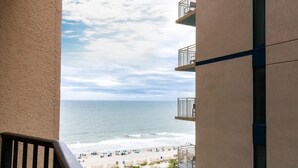 A balcony with a view of a beach and ocean. - Your Comfortable Resort View Room 9th Floor (Myrtle Beach)