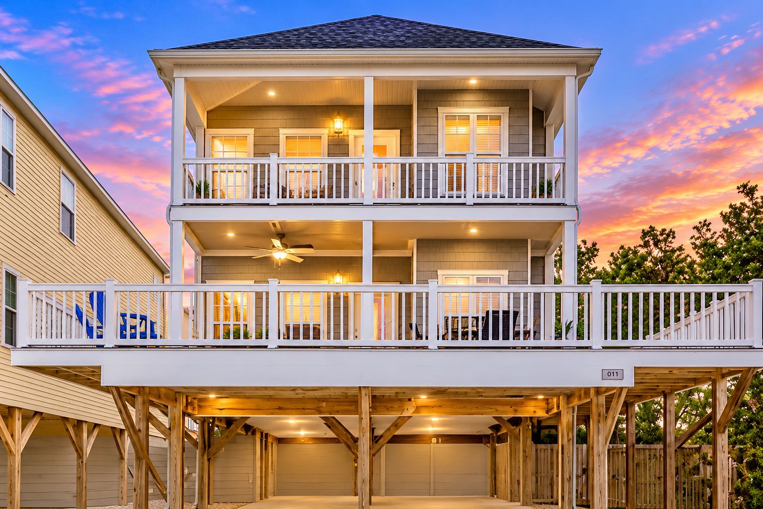 A two-story house with a balcony, a garage, and a covered deck area.