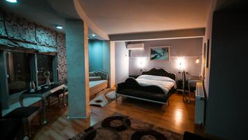 A modern bedroom with a bed, desk, and chair, featuring a unique wall design and a large window.