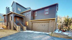 A two-story house with a garage, a staircase, and a front porch.