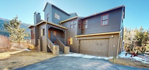 A two-story house with a garage, a staircase, and a front porch.