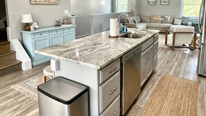 A modern kitchen with a marble countertop, stainless steel appliances, and pendant lighting. - Potomac Paradise - Water views within short walk to Colonial Beach, VA (Colonial Beach)