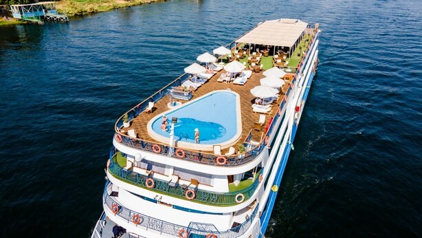 A cruise ship with a pool area on the upper deck, multiple decks, and lifebuoys. - Nile Cruise Luxor&Aswon IncludingTours (Luxor)