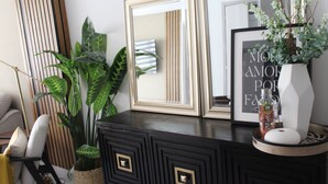 A black dresser with gold handles, a mirror, and a framed quote on the wall. - A Luxe family stay that is 5 minutes from the beach and a step away to the pool. (Punta Cana)