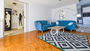 A living room with two blue sofas, a coffee table, and a patterned rug. - Lovely home in Privlaka (Privlaka)