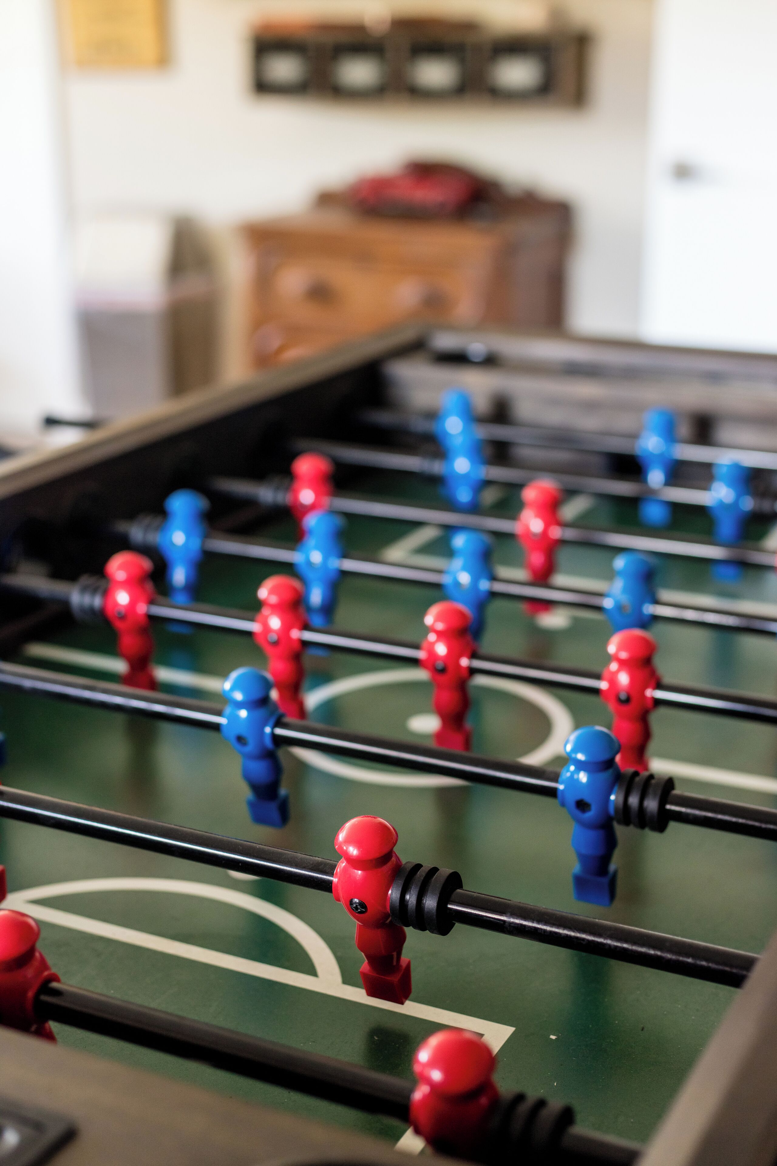 A foosball table with red and blue player figures.