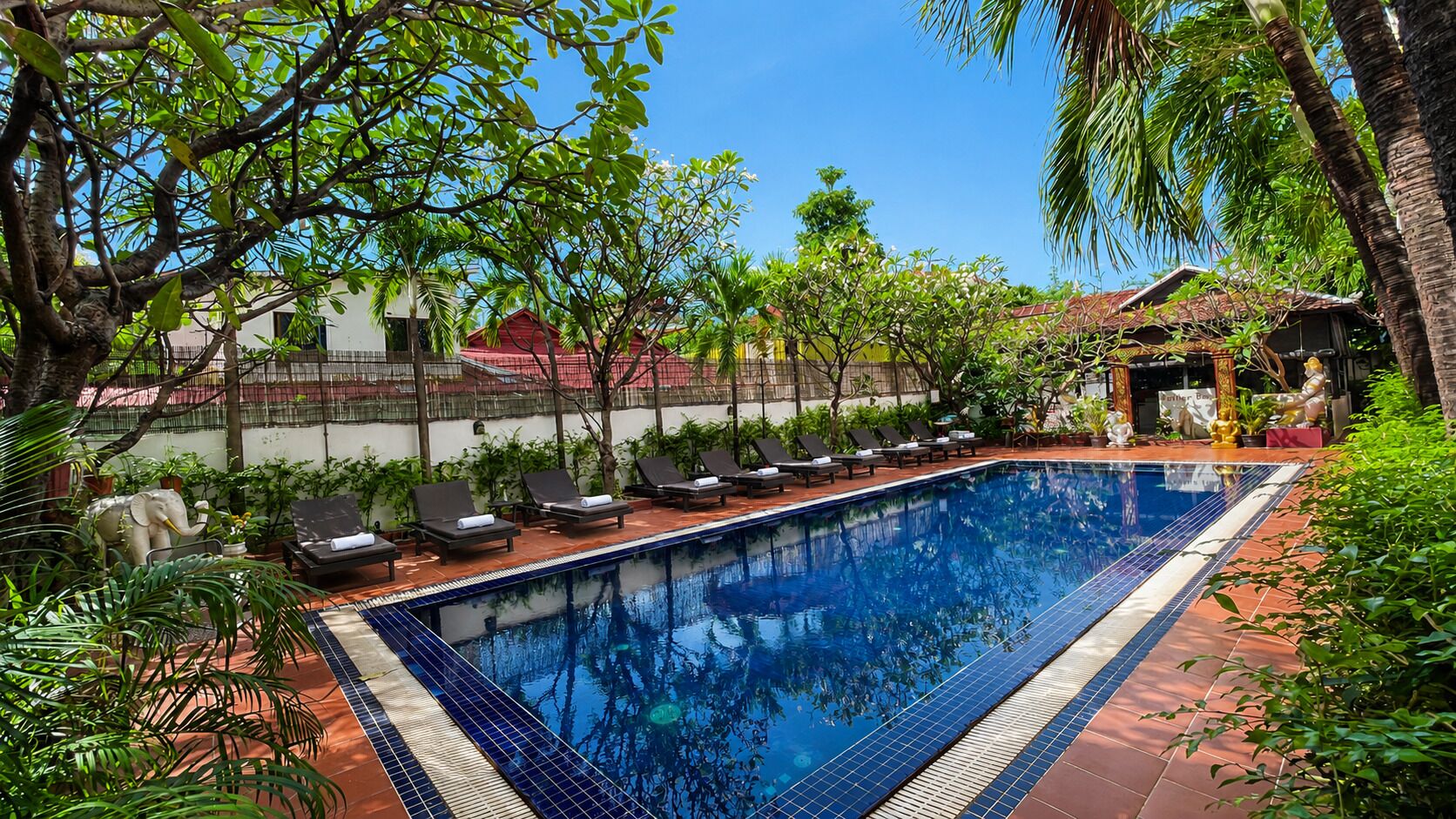 Outdoor pool, open 9:00 AM to 9:00 PM, pool loungers