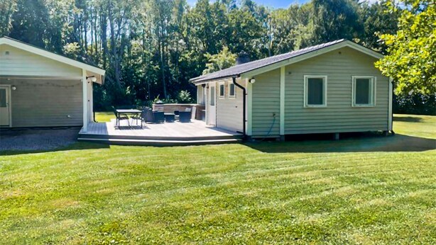 A two-story house with a covered patio and a garage. - Beautiful home in Färjestaden with WiFi (Färjestaden)