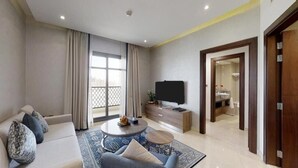 A modern living room with a sofa, coffee table, and TV.