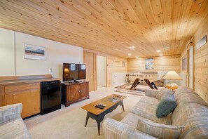 Cozy living room with a comfortable sofa, dining area, and fireplace.