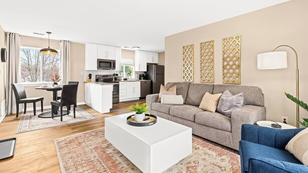 A modern apartment with a kitchen, dining area, and living room. - Charming New Unit in the Heart of Roseville (Roseville)