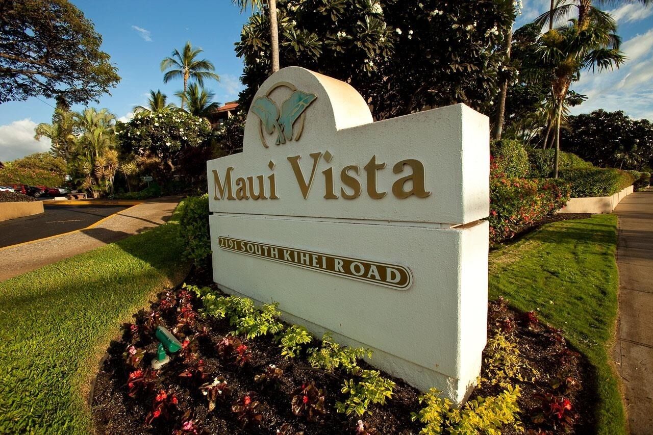 A sign for 'Maui Vista' at 2191 South Kihei Road, surrounded by lush greenery and palm trees.