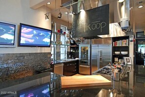 Welcome to the Koop, where a central island and stainless steel appliances make cooking a breeze.