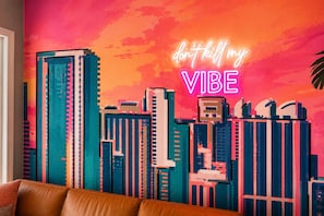 A vibrant cityscape mural with a neon sign that reads 'don't kill my VIBE' on a wall. - Miami & Me Oasis: Dive into Beach Bliss, King Size Comfort, and Gulfside Glam! (Indian Rocks Beach)
