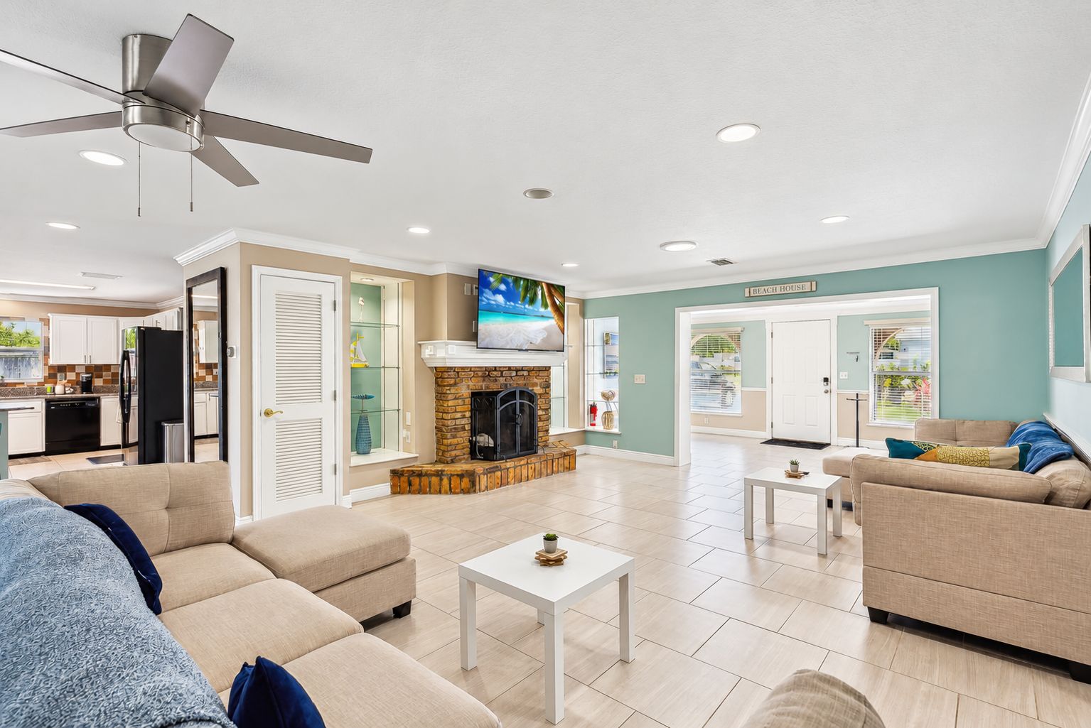 A modern living room with a fireplace, a television, and a dining area.