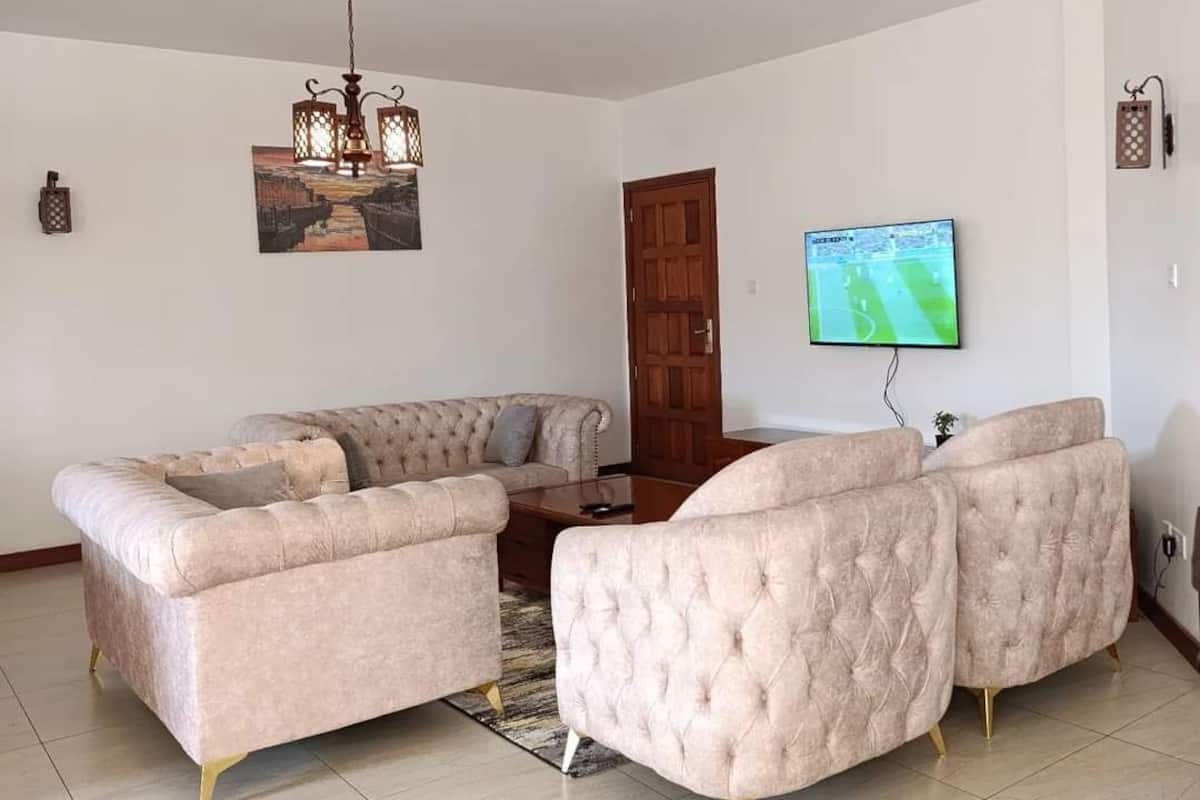 Executive Apartment | Living area | 55-inch Smart TV with satellite channels, Netflix, streaming services