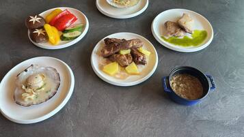A table with various dishes including seafood, meat, and vegetables.