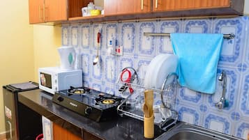 Fridge, microwave, cookware/dishes/utensils